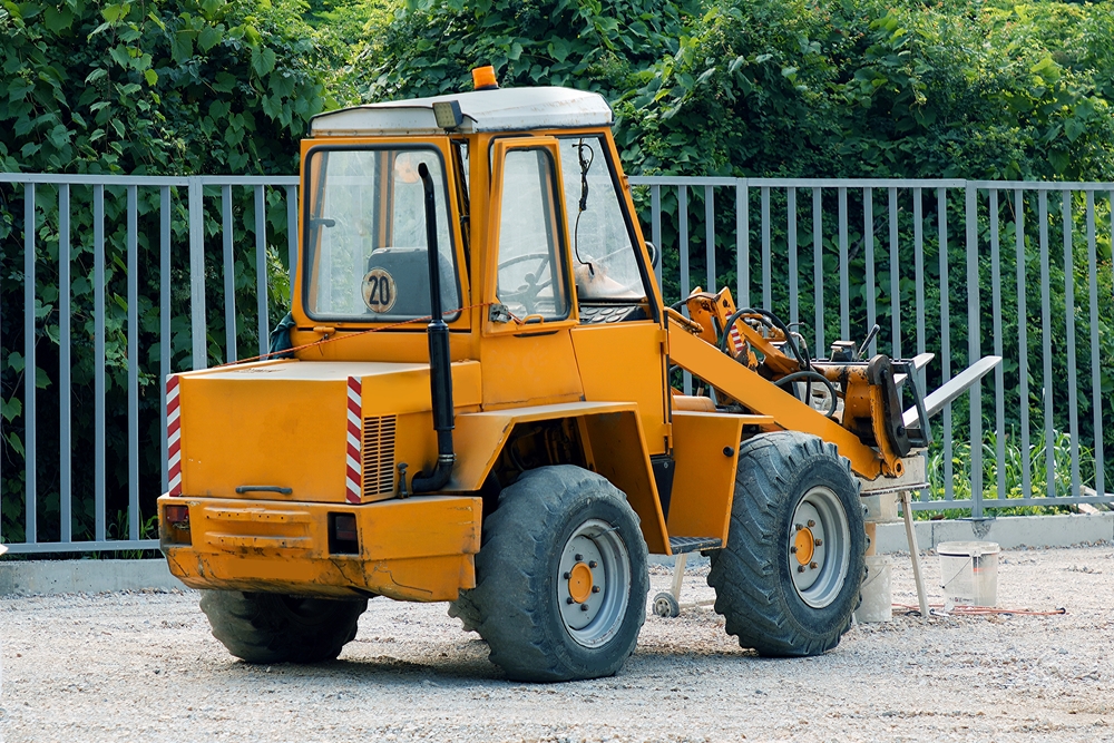 Extra large industrial forklift machine outside on construction site for moving heavy loads